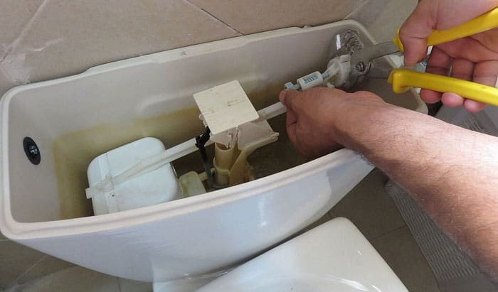 how to remove plastic nut from toilet tank